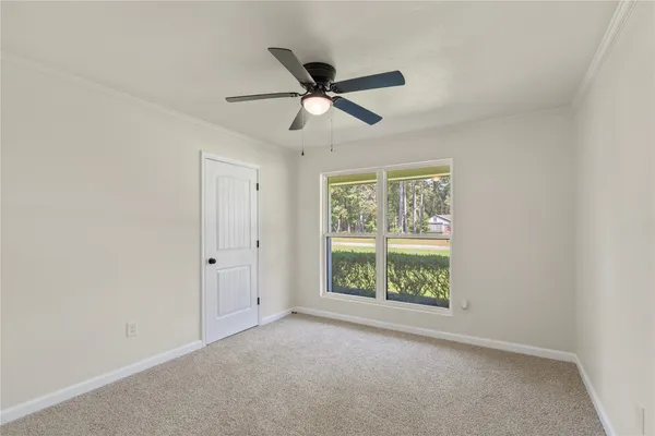 a view of workspace with window and ceiling fan