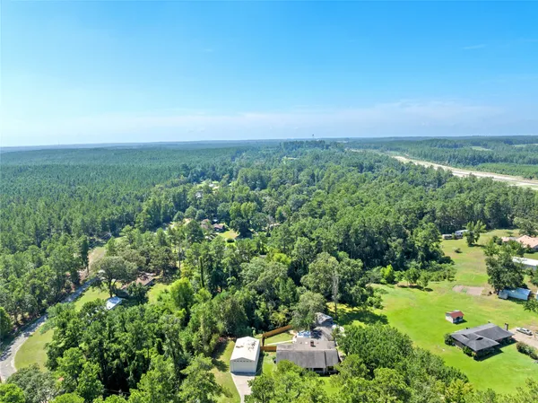 an aerial view of a houses with a yard