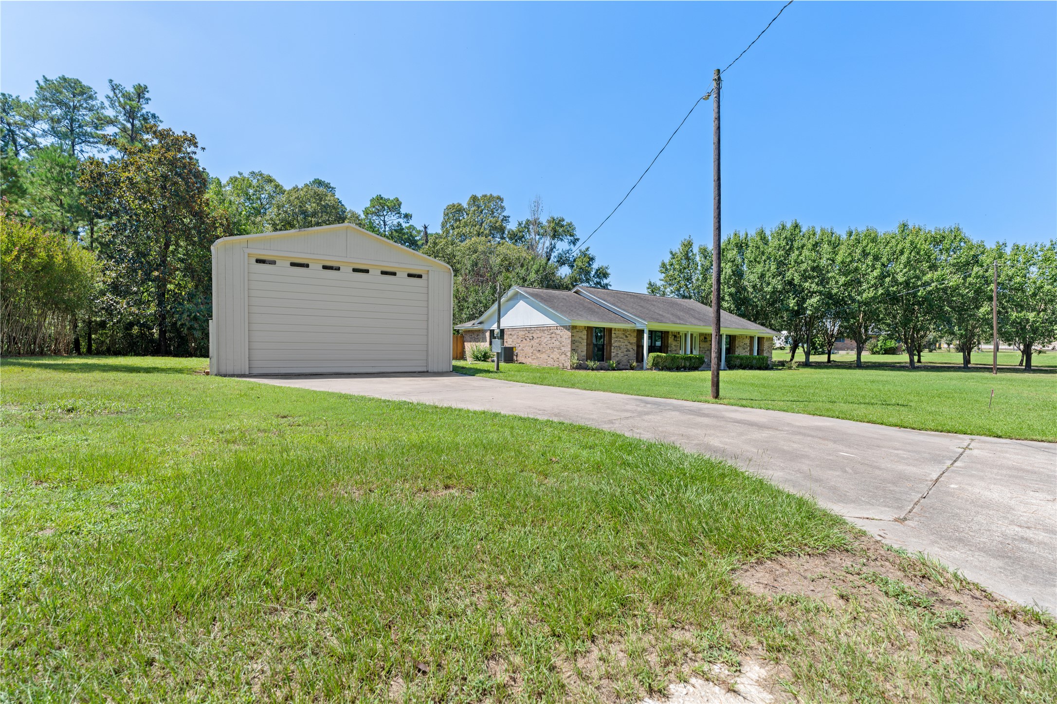 735 Laurelia Loop Corrigan, TX 75939 - Photo 5 of 44 with Huge Storage Building with Overhead Door with Concrete Drive