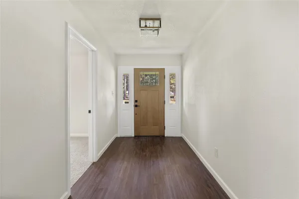 a view of a hallway with wooden floor