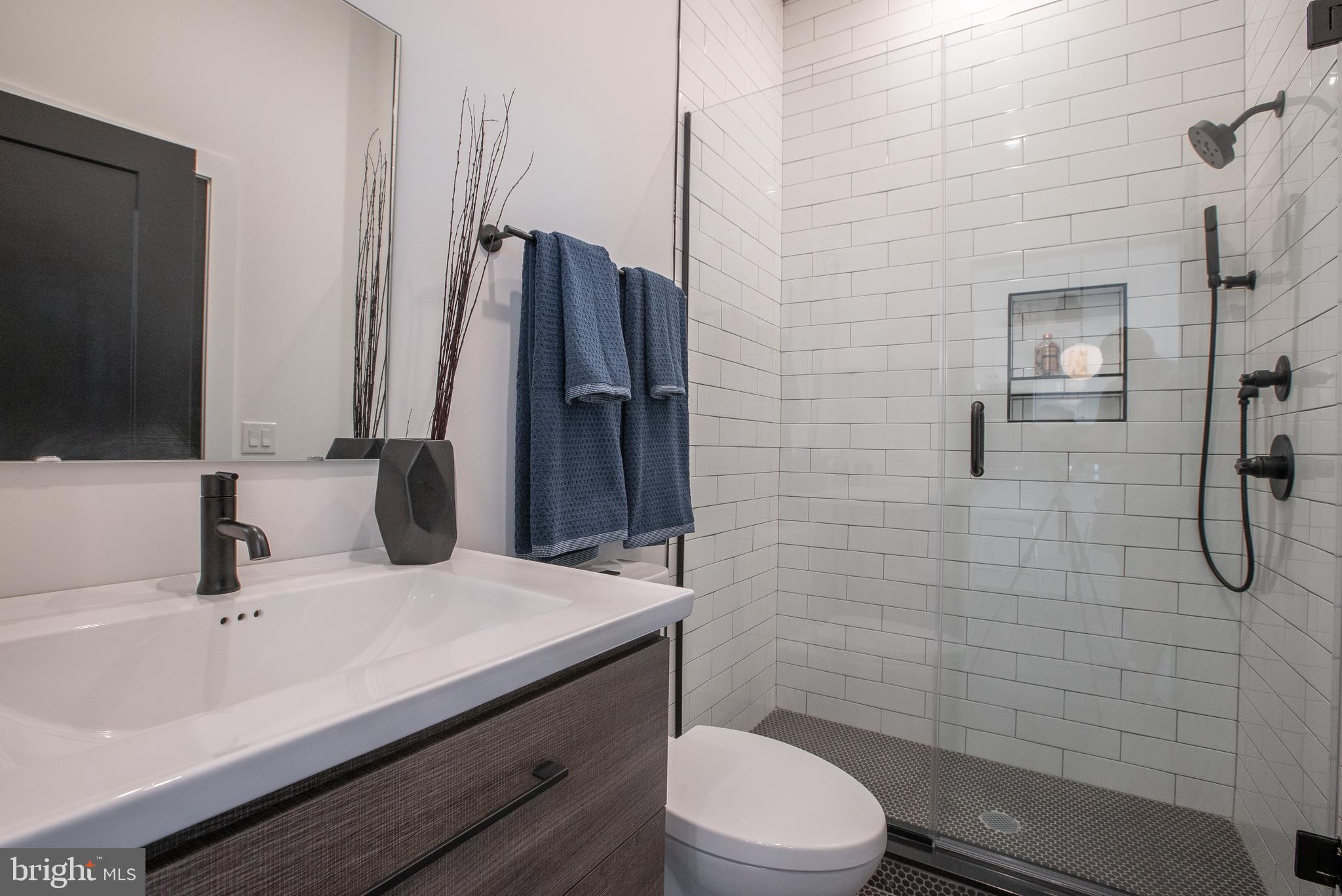 2940 West Thompson Street, Unit 305 Philadelphia, PA 19121 - Photo 12 of 24 a bathroom with a sink a toilet and shower