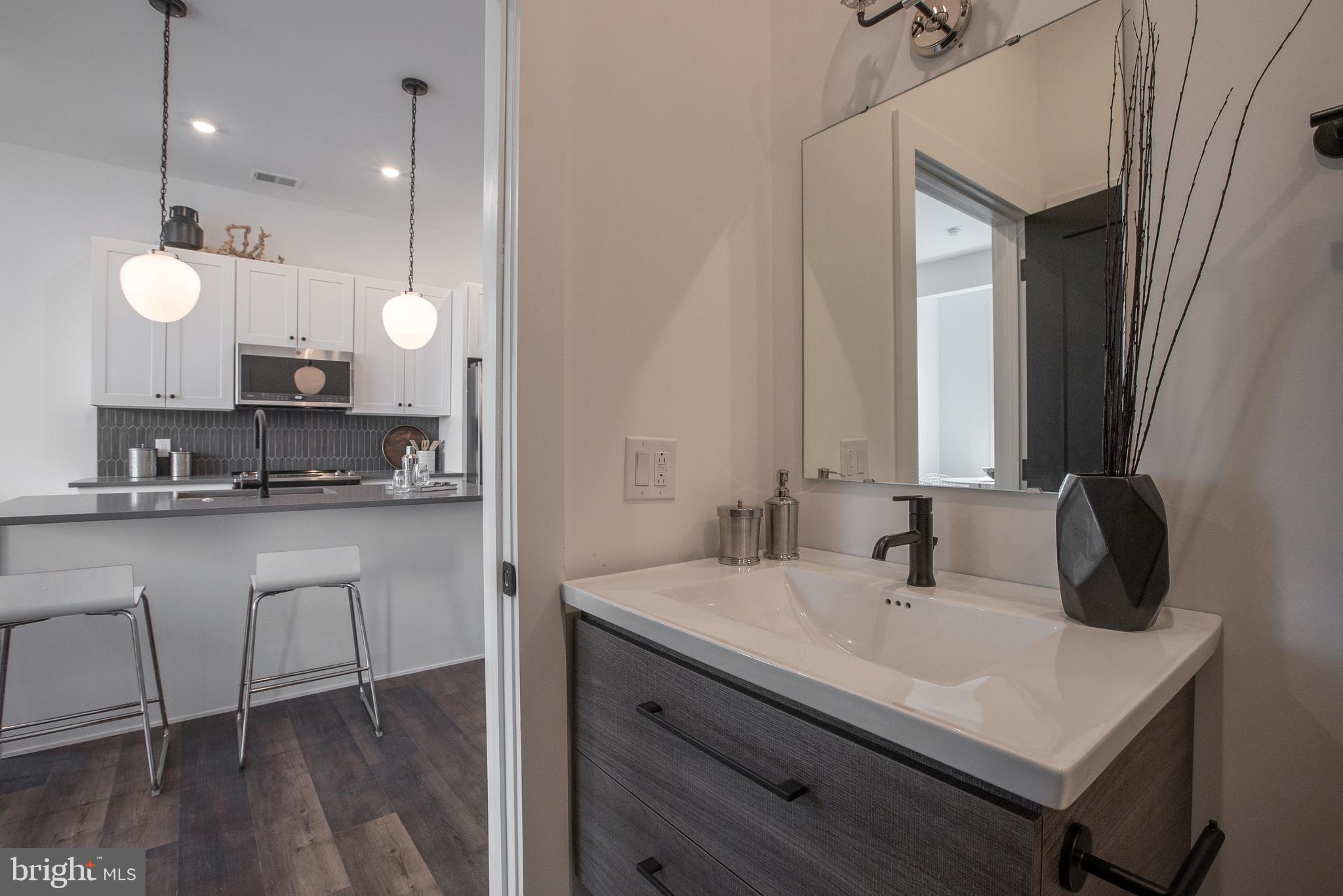 2940 West Thompson Street, Unit 305 Philadelphia, PA 19121 - Photo 15 of 24 a bathroom with a sink and a mirror