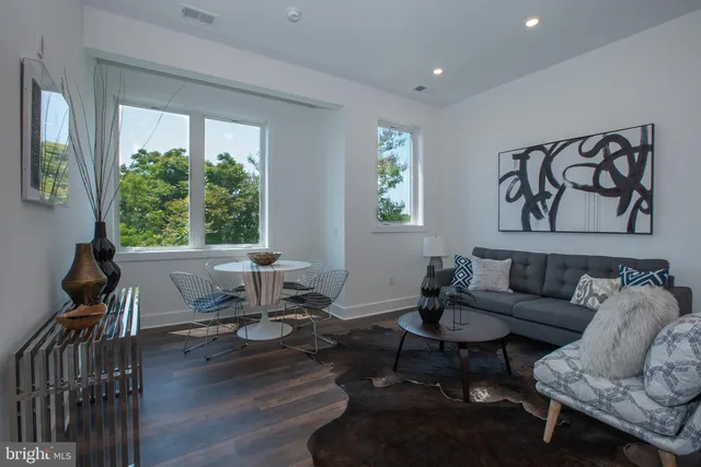 a living room with furniture and floor to ceiling windows