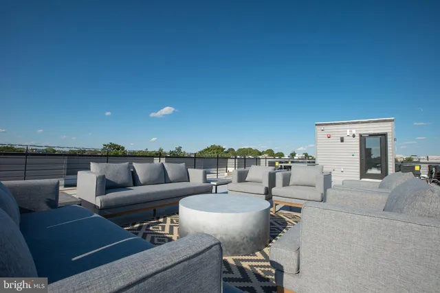 a view of a terrace with couches and city view
