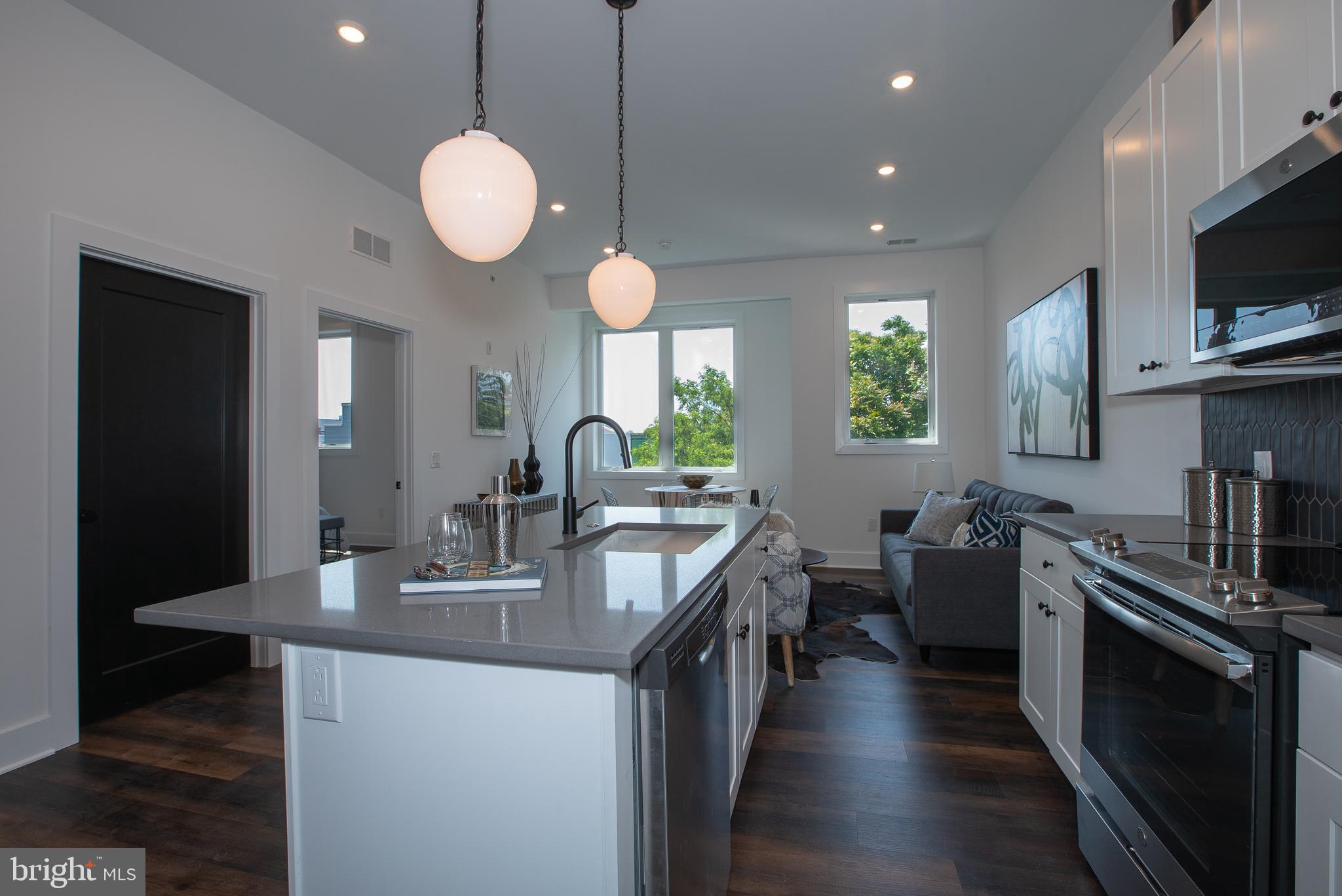 2940 West Thompson Street, Unit 305 Philadelphia, PA 19121 - Photo 3 of 24 a kitchen with counter top space appliances and wooden floor