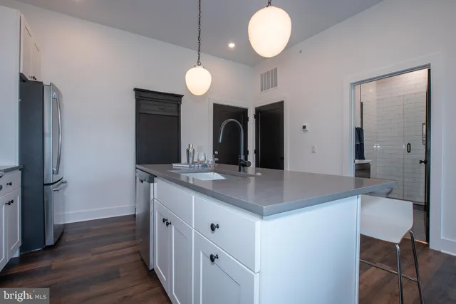 a kitchen with a sink and a refrigerator