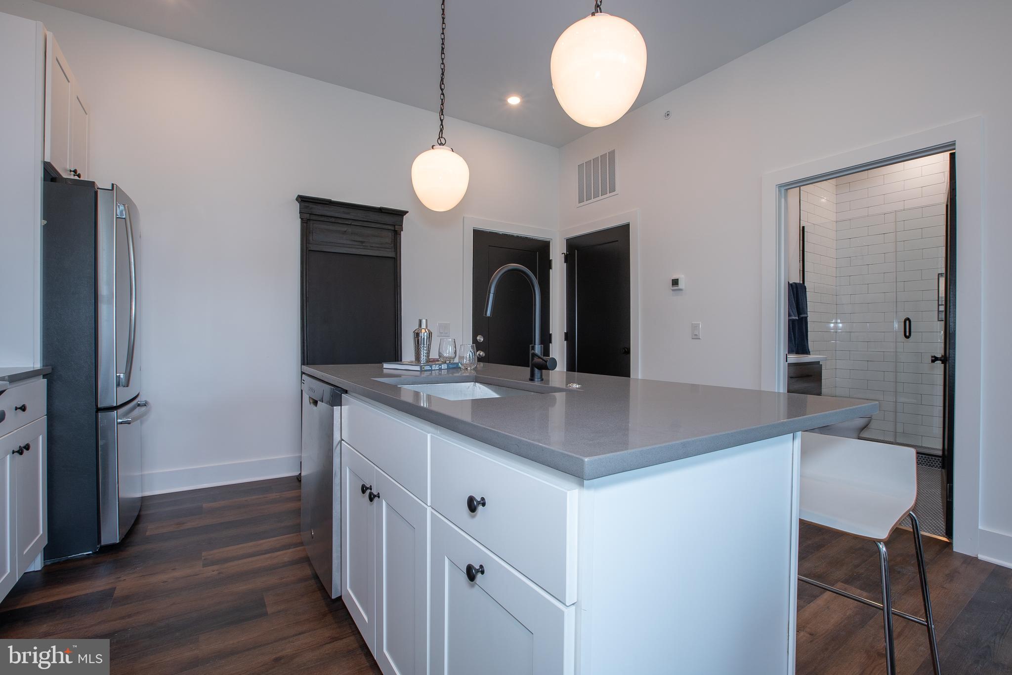 2940 West Thompson Street, Unit 305 Philadelphia, PA 19121 - Photo 5 of 24 a kitchen with a sink and a refrigerator