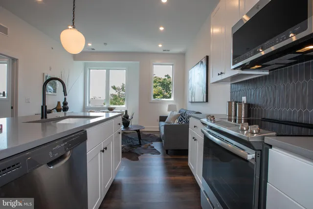 a kitchen with a sink stainless steel appliances and window