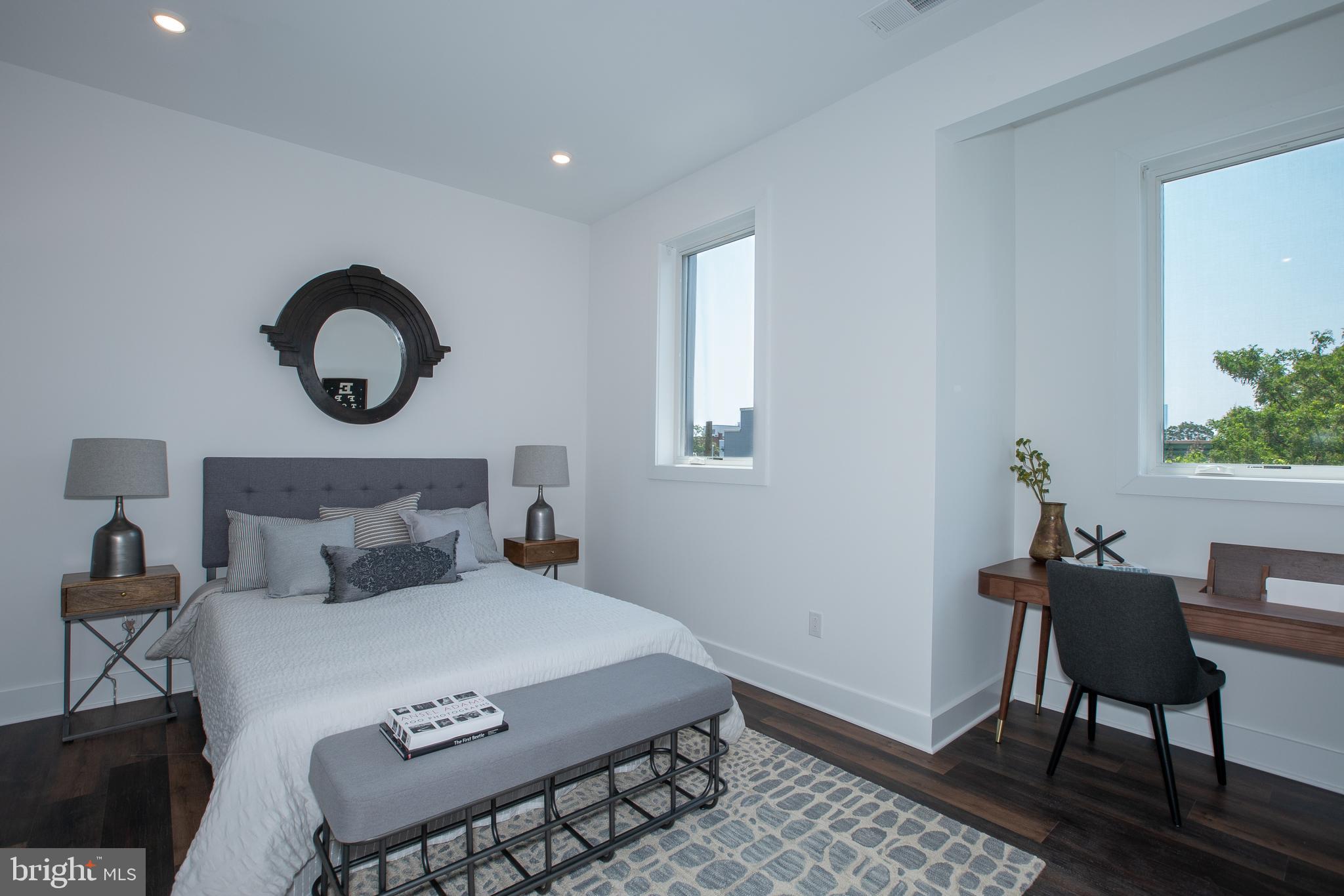 2940 West Thompson Street, Unit 305 Philadelphia, PA 19121 - Photo 8 of 24 a bedroom with a bed and a chair