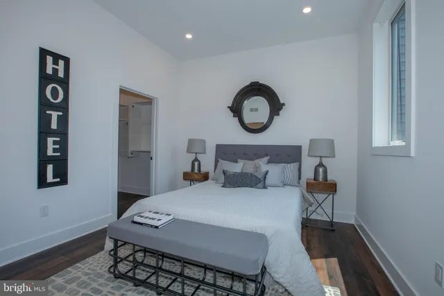 a bedroom with a bed and a chair in it