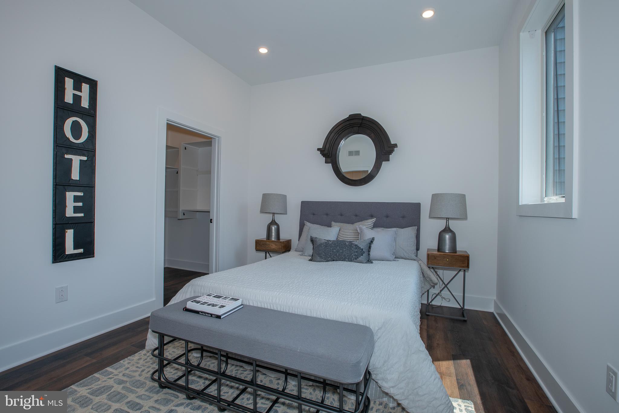 2940 West Thompson Street, Unit 305 Philadelphia, PA 19121 - Photo 9 of 24 a bedroom with a bed and a chair in it