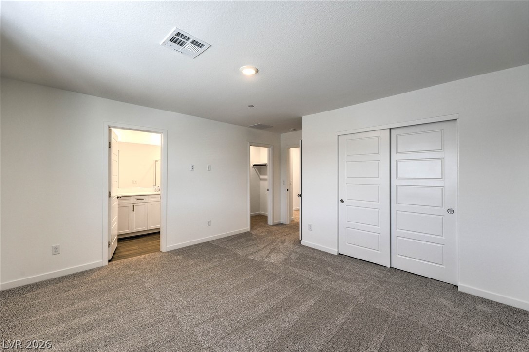 776 Fallen Phoenix Street Henderson, NV 89011 - Photo 12 of 30 Primary Bedroom features a Walk-in Closet and Bathroom with Dual Sinks and Shower