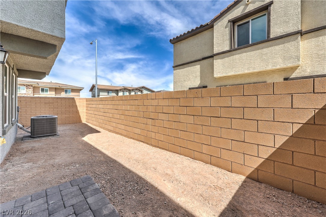 776 Fallen Phoenix Street Henderson, NV 89011 - Photo 24 of 30 Fully Fenced Rear Yard with BBQ Stub (Landlord is in the process of having a 10 x 12 Paver Patio, Synthetic Grass, Shrubs with Irrigation System, and Decorative Rock installed in Rear & Side Yards)