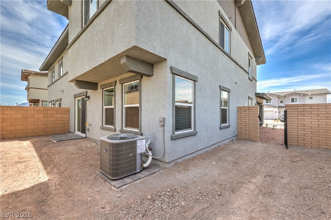 776 Fallen Phoenix Street Henderson, NV 89011 - Photo 25 of 30 Fully Fenced Rear Yard with BBQ Stub (Landlord is in the process of having a 10 x 12 Paver Patio, Synthetic Grass, Shrubs with Irrigation System, and Decorative Rock installed in Rear & Side Yards)