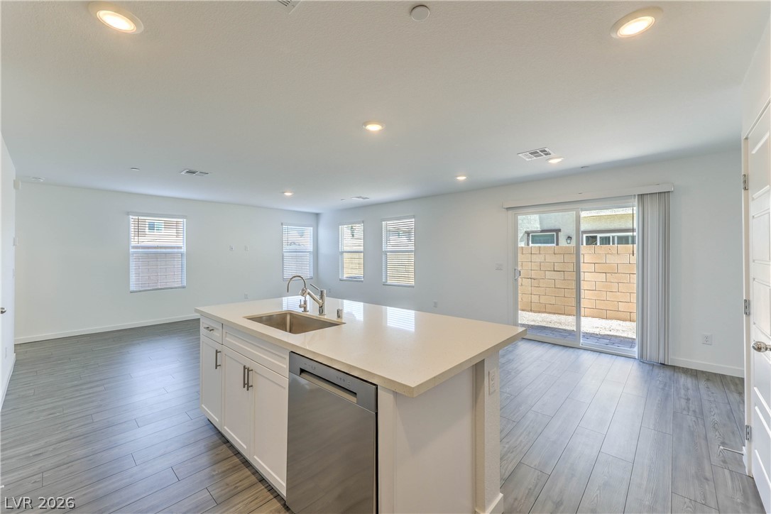 776 Fallen Phoenix Street Henderson, NV 89011 - Photo 9 of 30 Island Kitchen boasts Quartz Countertops, White Cabinets, Breakfast Bar, Pantry, 6 stage iSpring RO System, Recessed Lighting, and Stainless-Steel Gas Stove, Microwave, Dishwasher, and Refrigerator