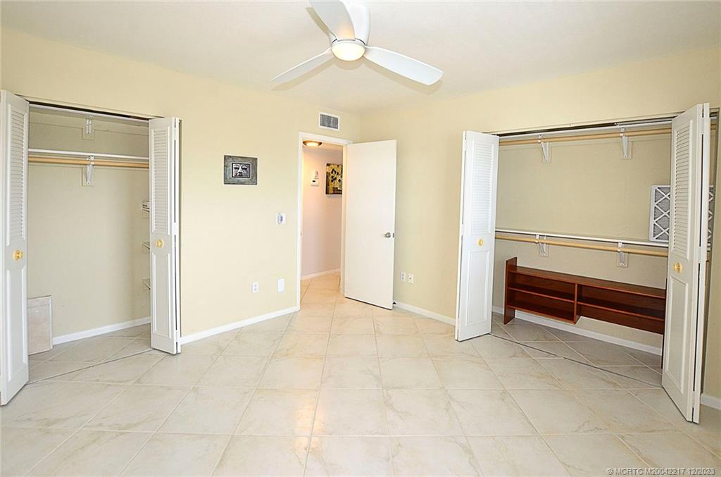 1866 Southwest Palm City Road, Unit 302 Stuart, FL 34994 - Photo 18 of 30 a view of an empty room with closet and a fan