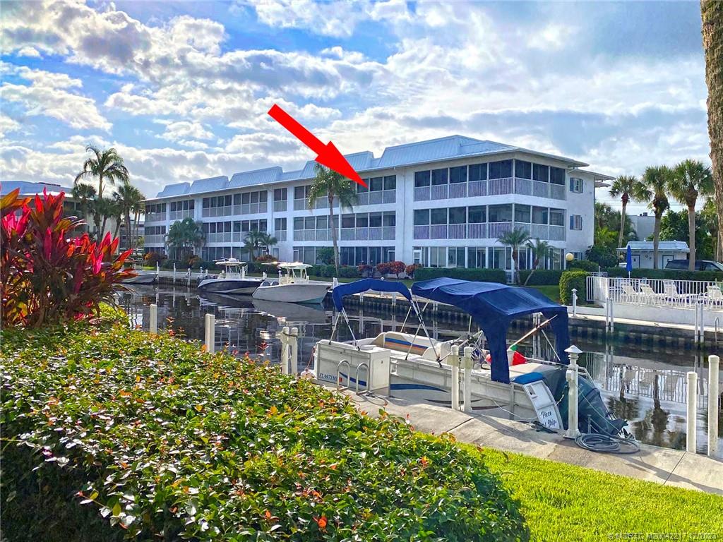 1866 Southwest Palm City Road, Unit 302 Stuart, FL 34994 - Photo 2 of 30 a front view of building with outdoor seating and city view
