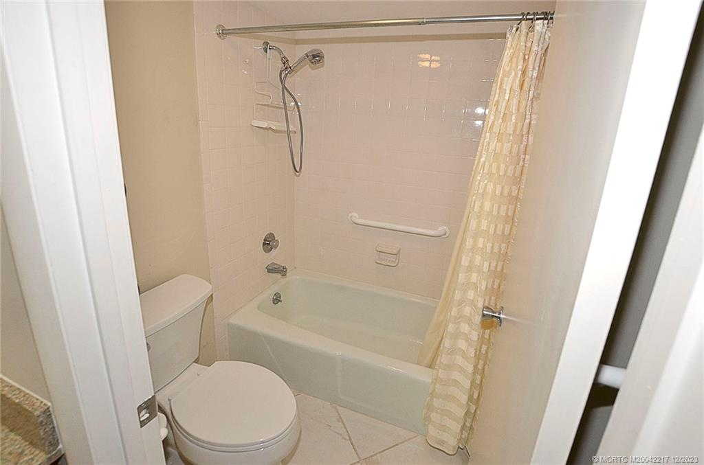1866 Southwest Palm City Road, Unit 302 Stuart, FL 34994 - Photo 24 of 30 a bathroom with a toilet and a shower