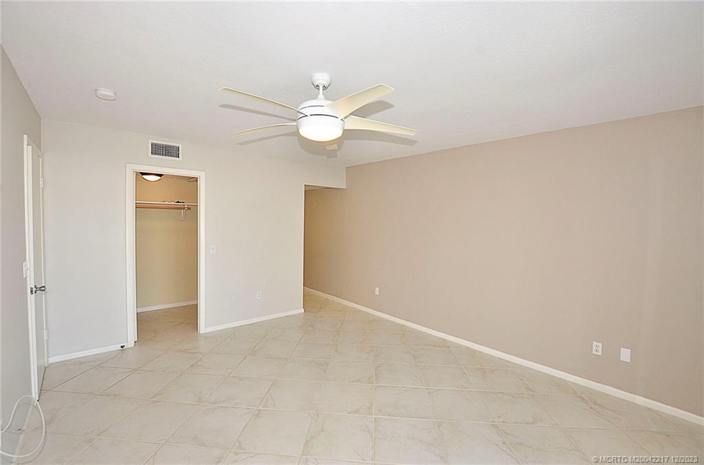 1866 Southwest Palm City Road, Unit 302 Stuart, FL 34994 - Photo 26 of 30 an empty room with a ceiling fan and a window
