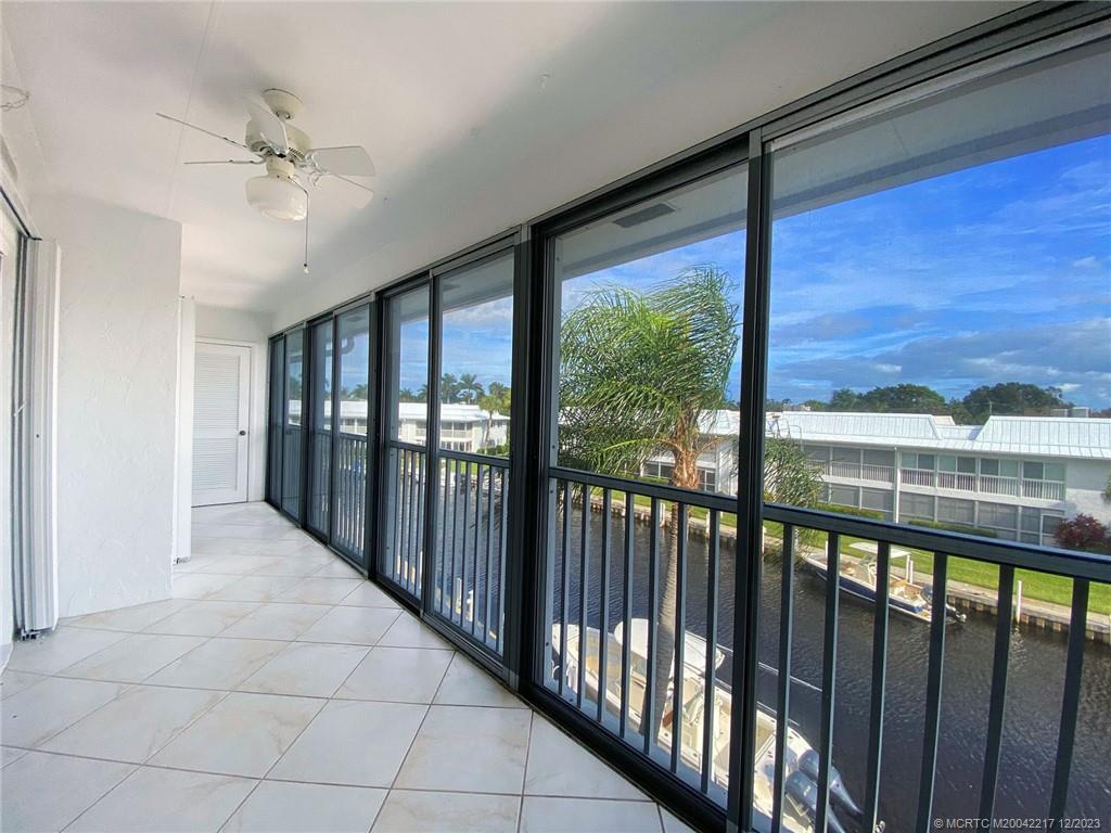 1866 Southwest Palm City Road, Unit 302 Stuart, FL 34994 - Photo 28 of 30 a view of a glass door with a porch