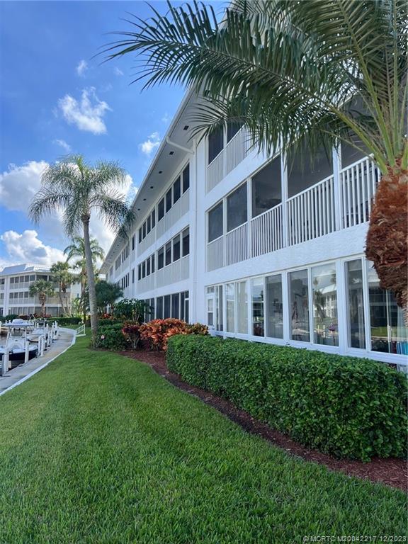 1866 Southwest Palm City Road, Unit 302 Stuart, FL 34994 - Photo 6 of 30 a view of a building with a yard