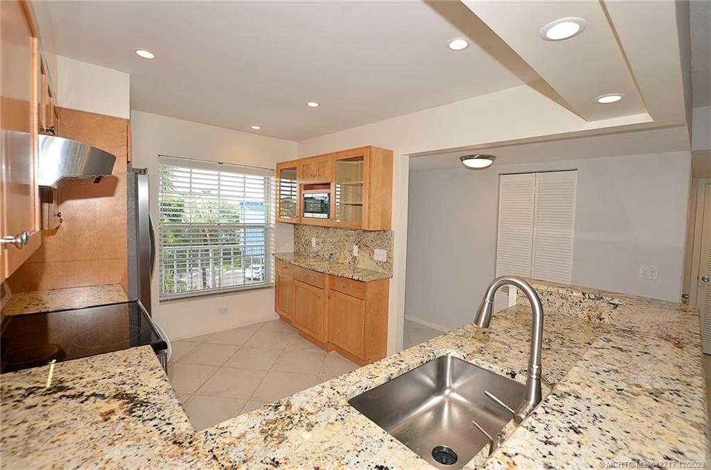 1866 Southwest Palm City Road, Unit 302 Stuart, FL 34994 - Photo 8 of 30 a kitchen with a sink and a refrigerator