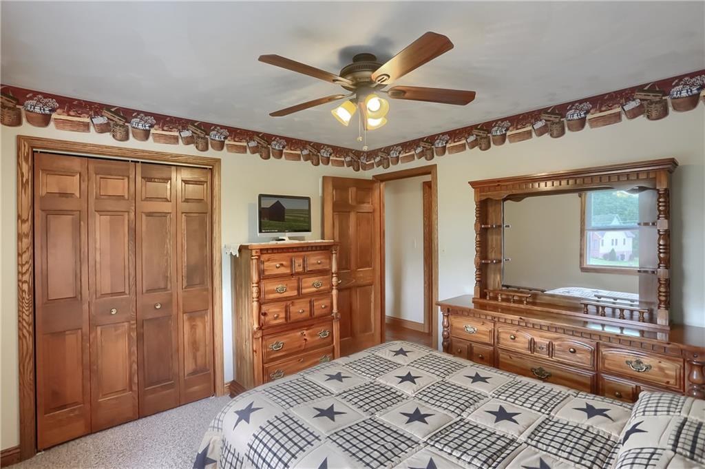 287 Holyoke Road Butler, PA 16001 - Photo 19 of 35 a bedroom with a bed and a chandelier