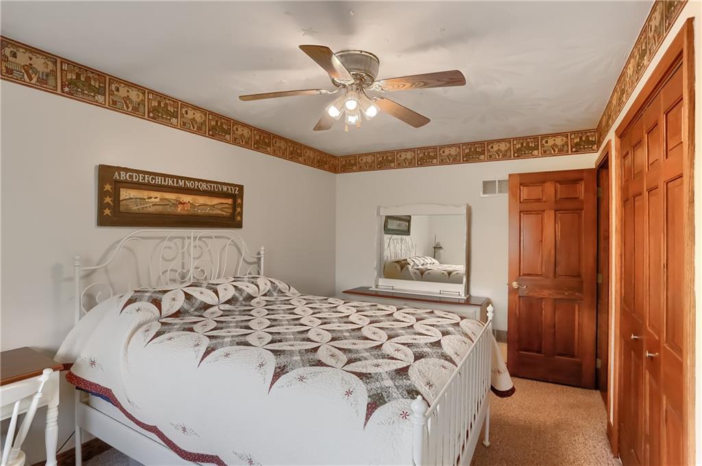 287 Holyoke Road Butler, PA 16001 - Photo 20 of 35 a bedroom with a bed and a chandelier