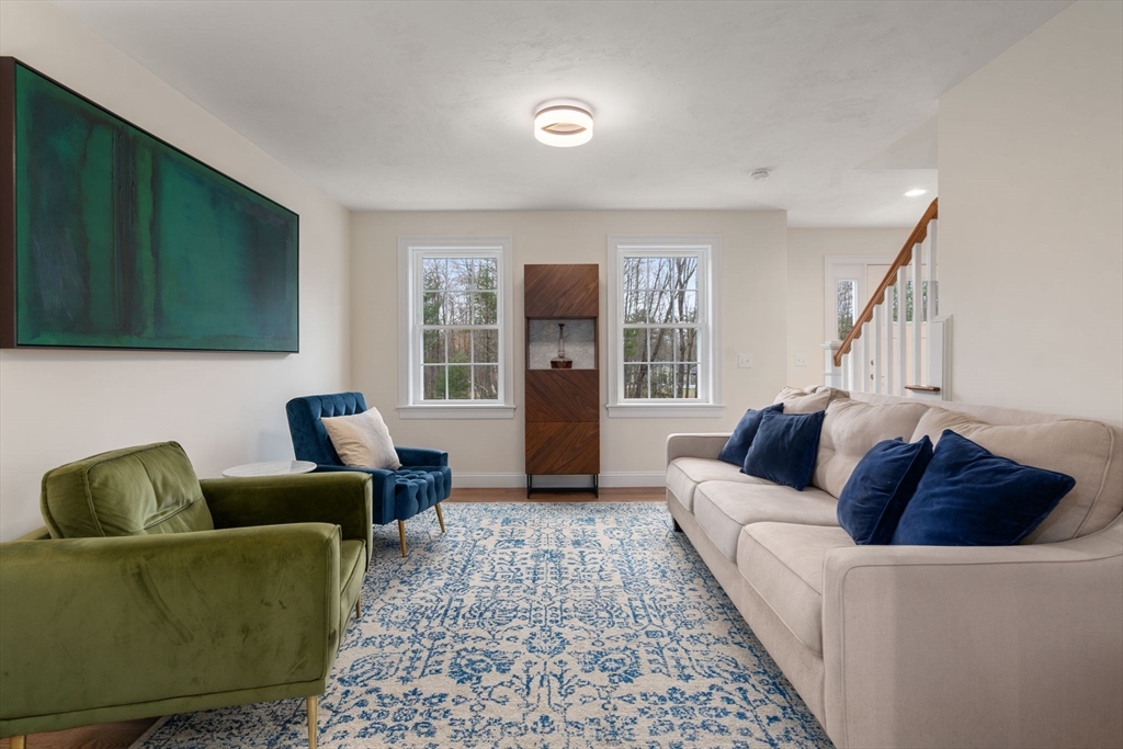 813 Chase Road Lunenburg, MA 01462 - Photo 11 of 41 a living room with furniture and a window