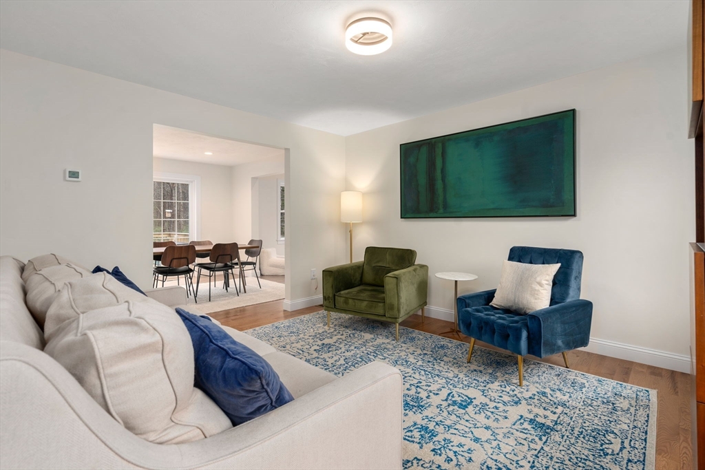 813 Chase Road Lunenburg, MA 01462 - Photo 12 of 41 a living room with furniture and a flat screen tv