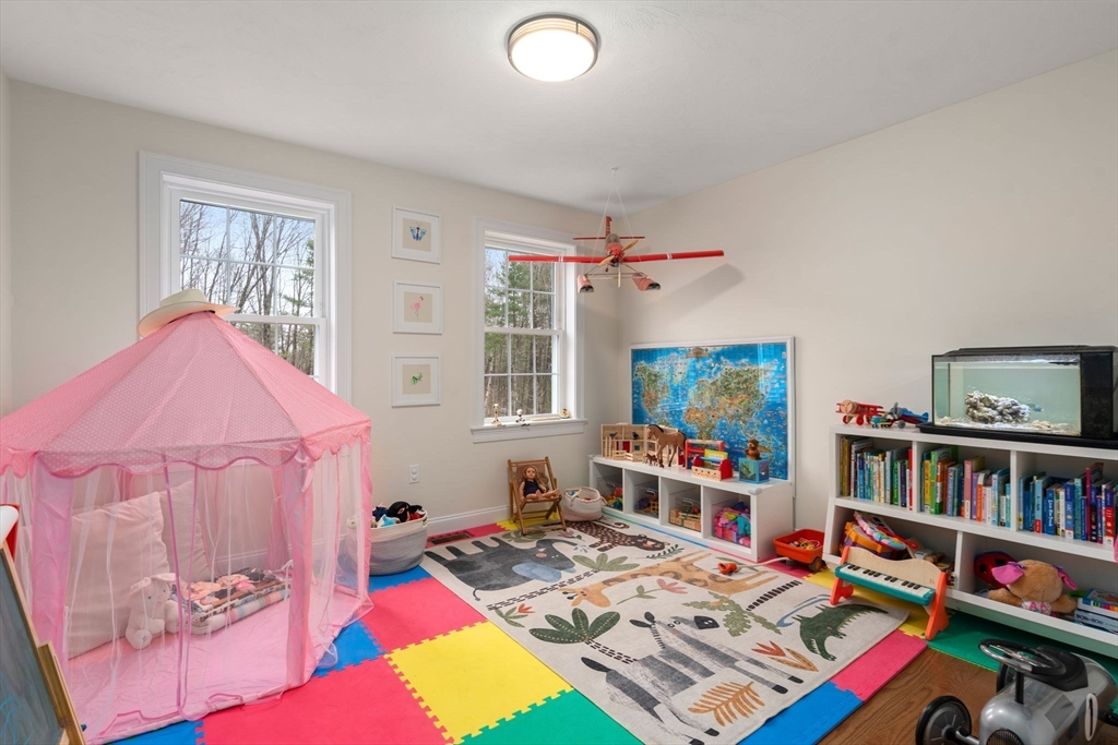 813 Chase Road Lunenburg, MA 01462 - Photo 13 of 41 a bedroom with furniture and a book shelf