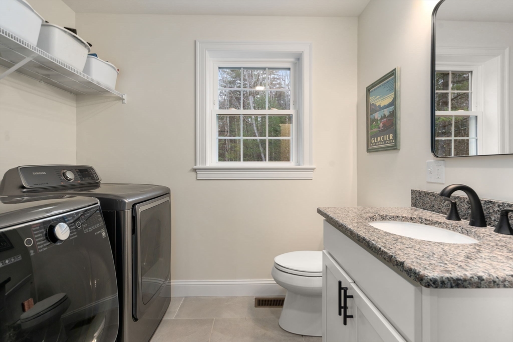 813 Chase Road Lunenburg, MA 01462 - Photo 14 of 41 a bathroom with a granite countertop toilet sink and mirror