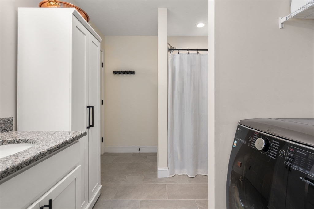 813 Chase Road Lunenburg, MA 01462 - Photo 15 of 41 a bathroom with a granite countertop sink and a mirror