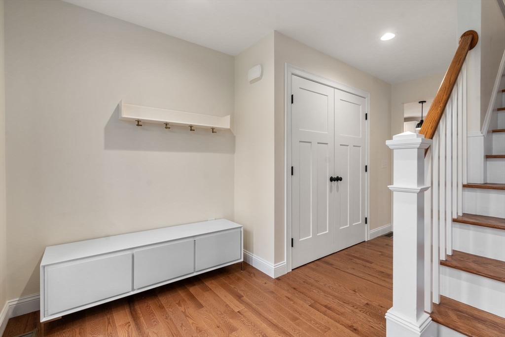 813 Chase Road Lunenburg, MA 01462 - Photo 16 of 41 a view of room with wooden floor and staircase