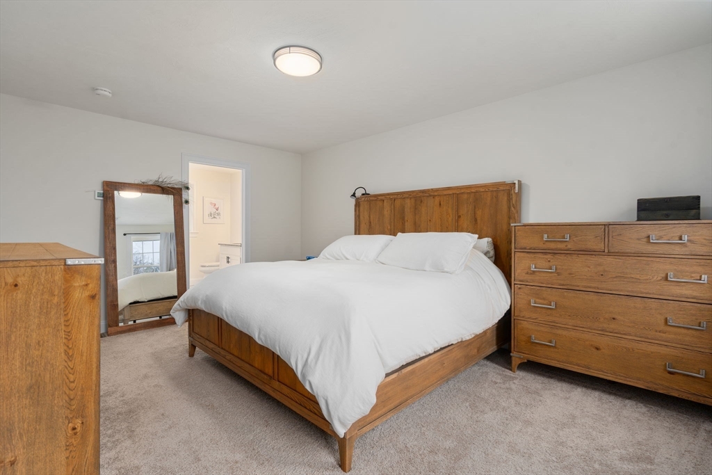 813 Chase Road Lunenburg, MA 01462 - Photo 19 of 41 a bed room with a bed and a night stand
