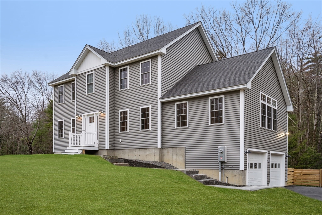 813 Chase Road Lunenburg, MA 01462 - Photo 2 of 41 a front view of a house with a garden