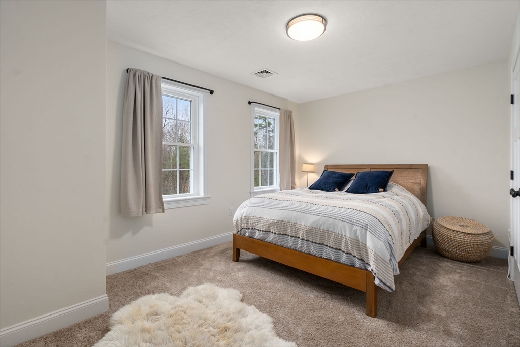 813 Chase Road Lunenburg, MA 01462 - Photo 22 of 41 a bedroom with a bed and a window