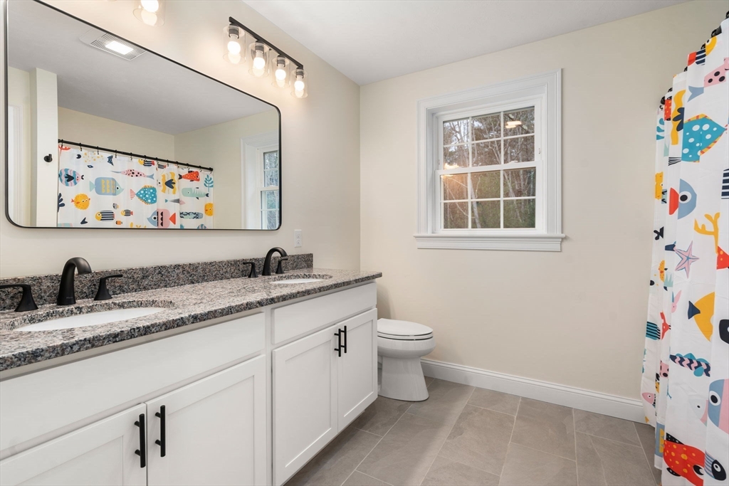 813 Chase Road Lunenburg, MA 01462 - Photo 25 of 41 a bathroom with a granite countertop sink and a mirror