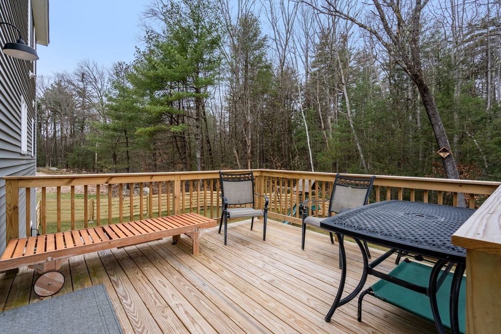 813 Chase Road Lunenburg, MA 01462 - Photo 30 of 41 a view of a wooden deck with furniture