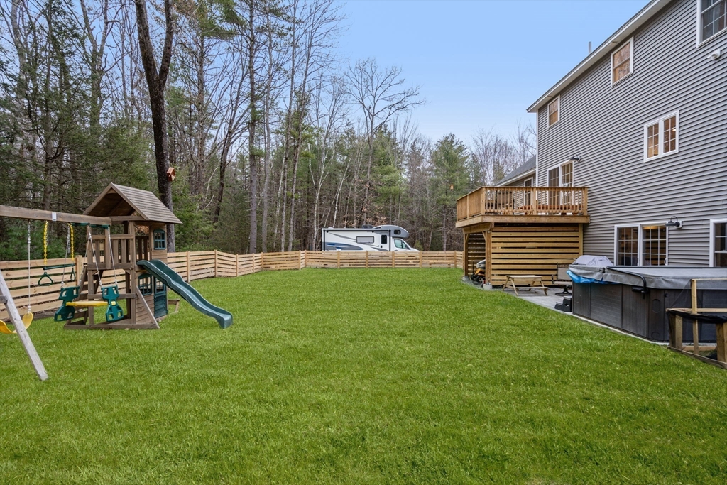 813 Chase Road Lunenburg, MA 01462 - Photo 36 of 41 a view of a house with a backyard and a slide