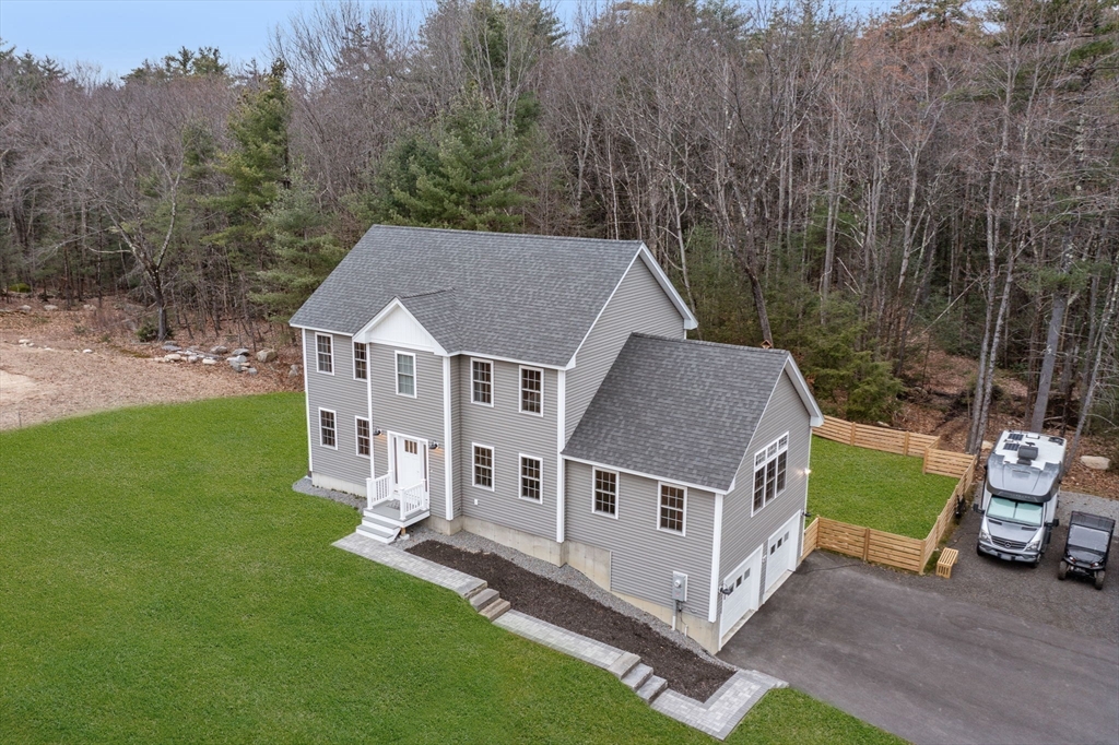 813 Chase Road Lunenburg, MA 01462 - Photo 38 of 41 a aerial view of a house with a yard table and chairs