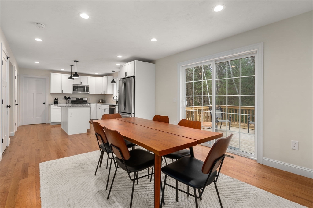 813 Chase Road Lunenburg, MA 01462 - Photo 7 of 41 a dining room with furniture and a kitchen view