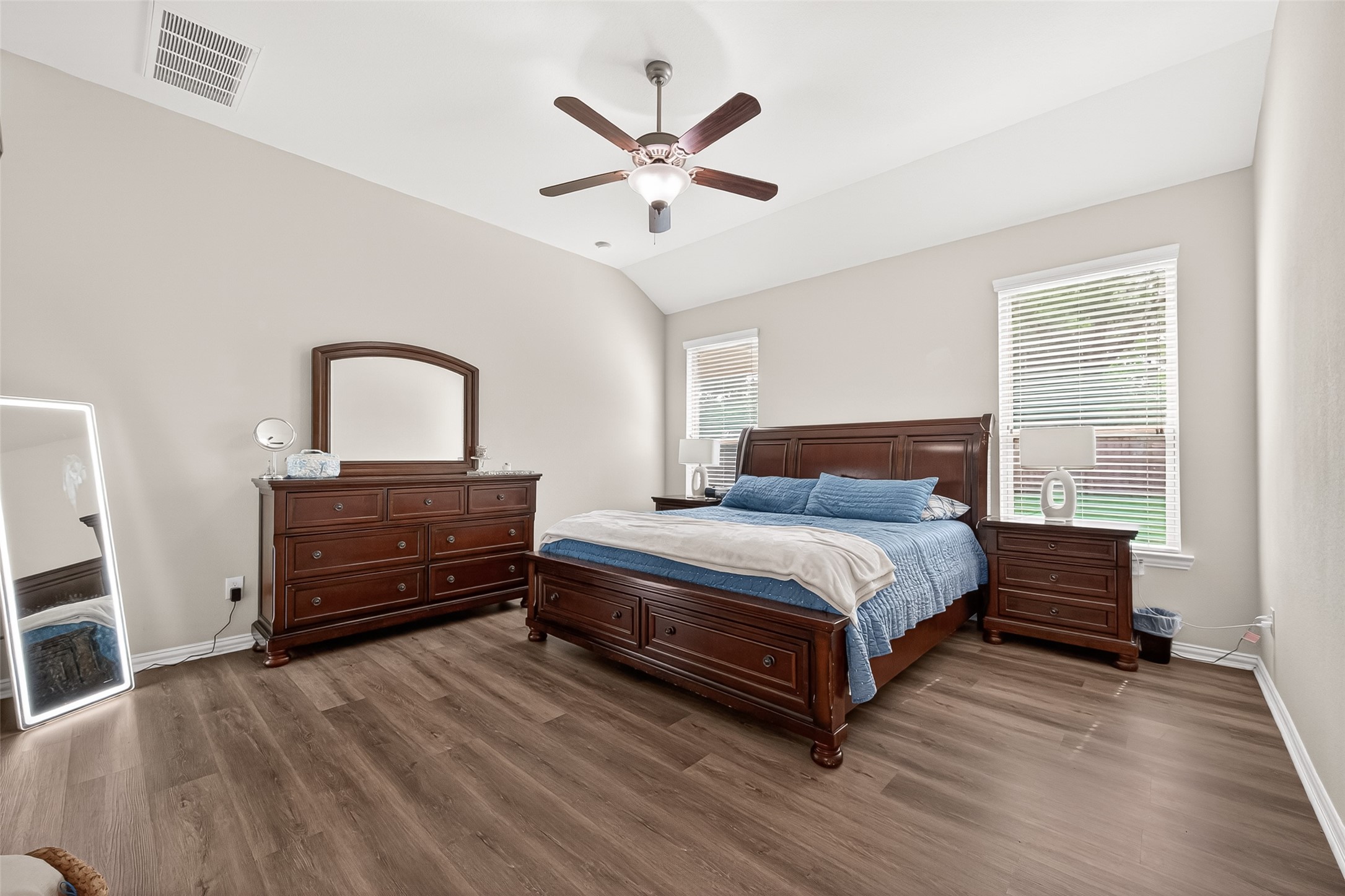8 Landscape Court Conroe, TX 77301 - Photo 23 of 43 a bedroom with a bed and wooden floor