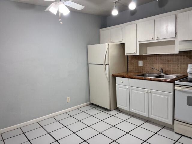 1721 Northwest 15th Vista, Unit 12 Boca Raton, FL 33432 - Photo 5 of 8 a kitchen with cabinets and stainless steel appliances