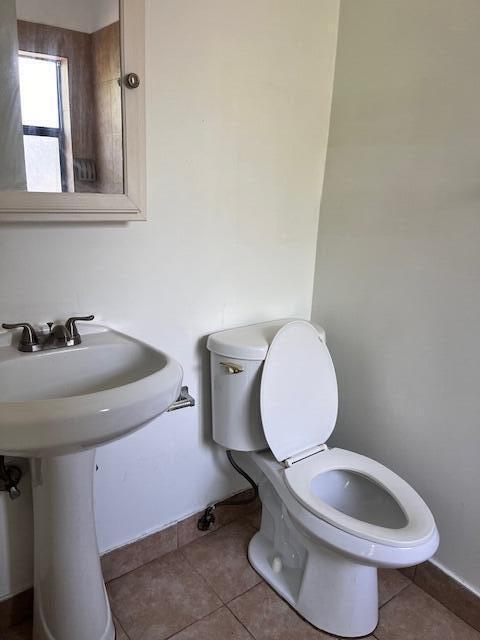 1721 Northwest 15th Vista, Unit 12 Boca Raton, FL 33432 - Photo 7 of 8 a bathroom with a toilet sink and mirror