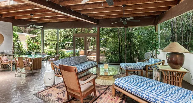a patio with glass top table and chairs