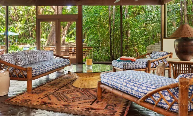 a view of a patio with a table chairs and a backyard