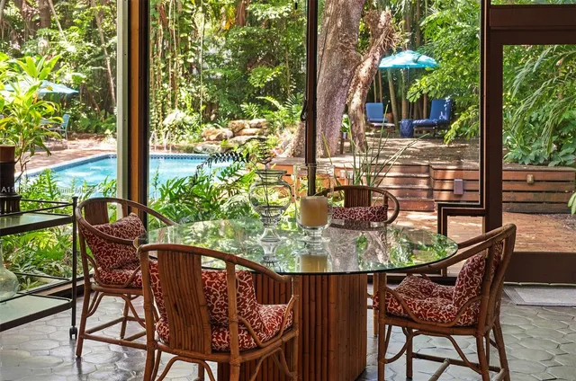 a view of a wooden table and chairs in patio