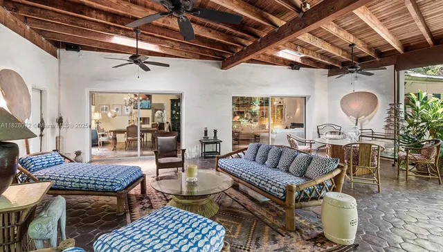 a living room with furniture a rug and a chandelier