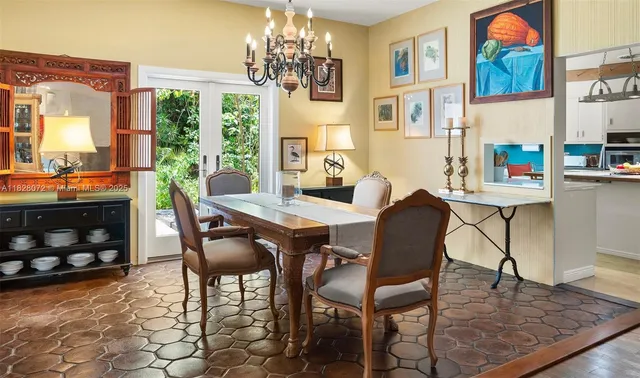 a view of a dining room with furniture a chandelier and wooden floor